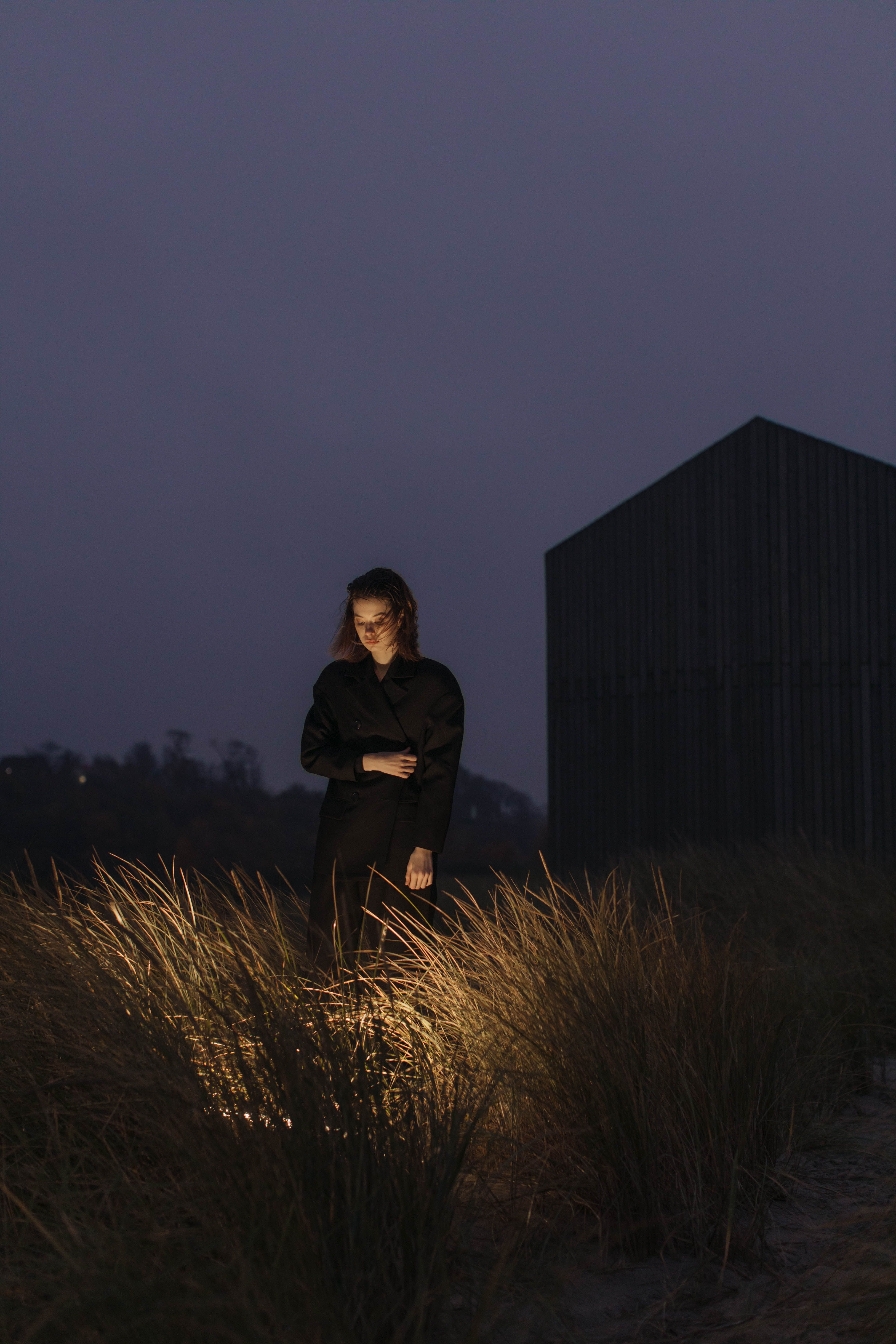 Woman in Black Jacket Standing on Green Grass Field · Free Stock Photo