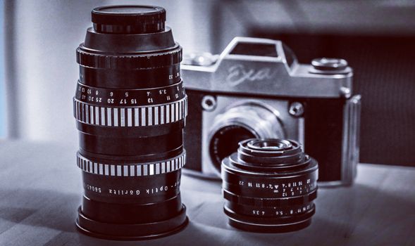 Close-up shot of a vintage film camera with classic lenses showcasing analog photography nostalgia.