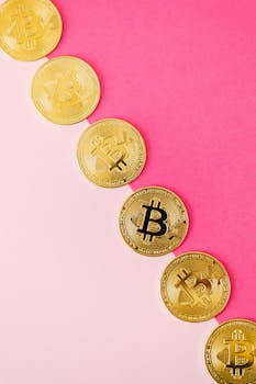 Golden Bitcoin coins arranged on a vibrant pink surface, showcasing cryptocurrency and finance themes.