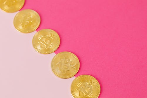 Free Gold Coins on Pink Surface Stock Photo
