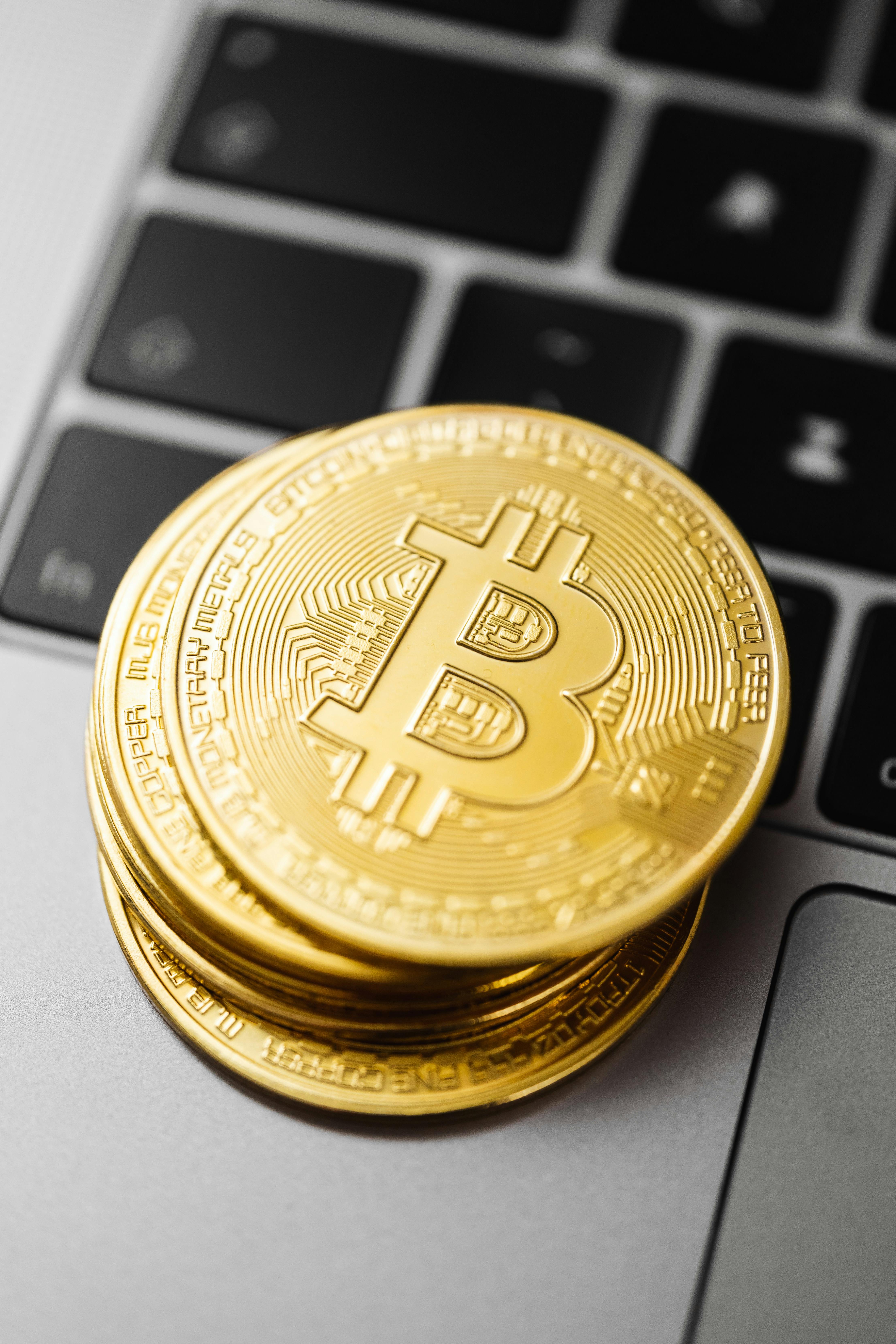 gold bitcoin cryptocurrency coins on a laptop