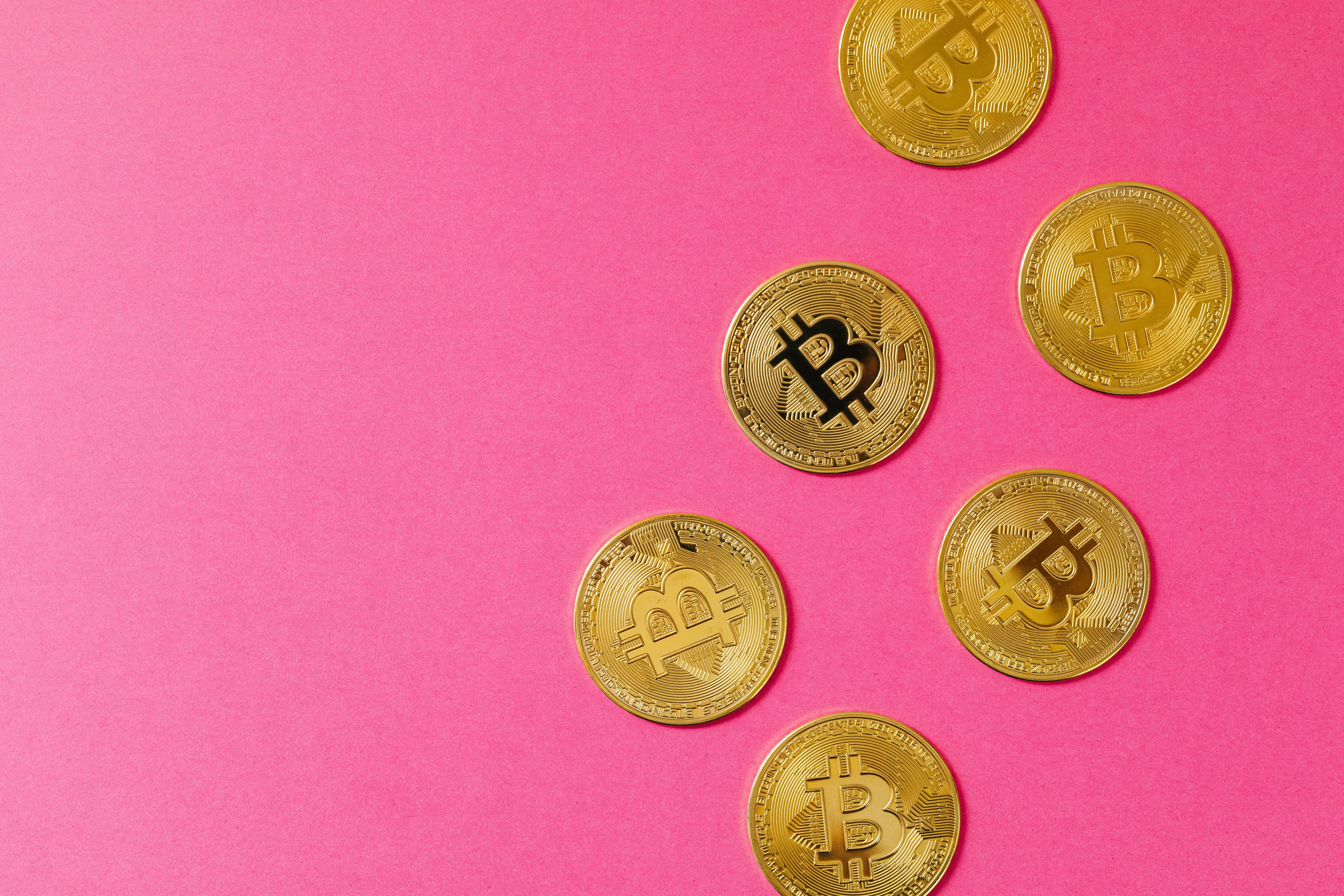 gold round coins on pink surface