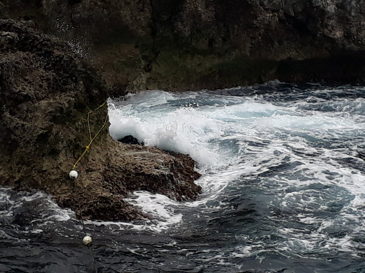 Bitcoin token placed on a laptop keyboard with candlestick price charts in the background, symbolizing the convergence of crypto and traditional markets.