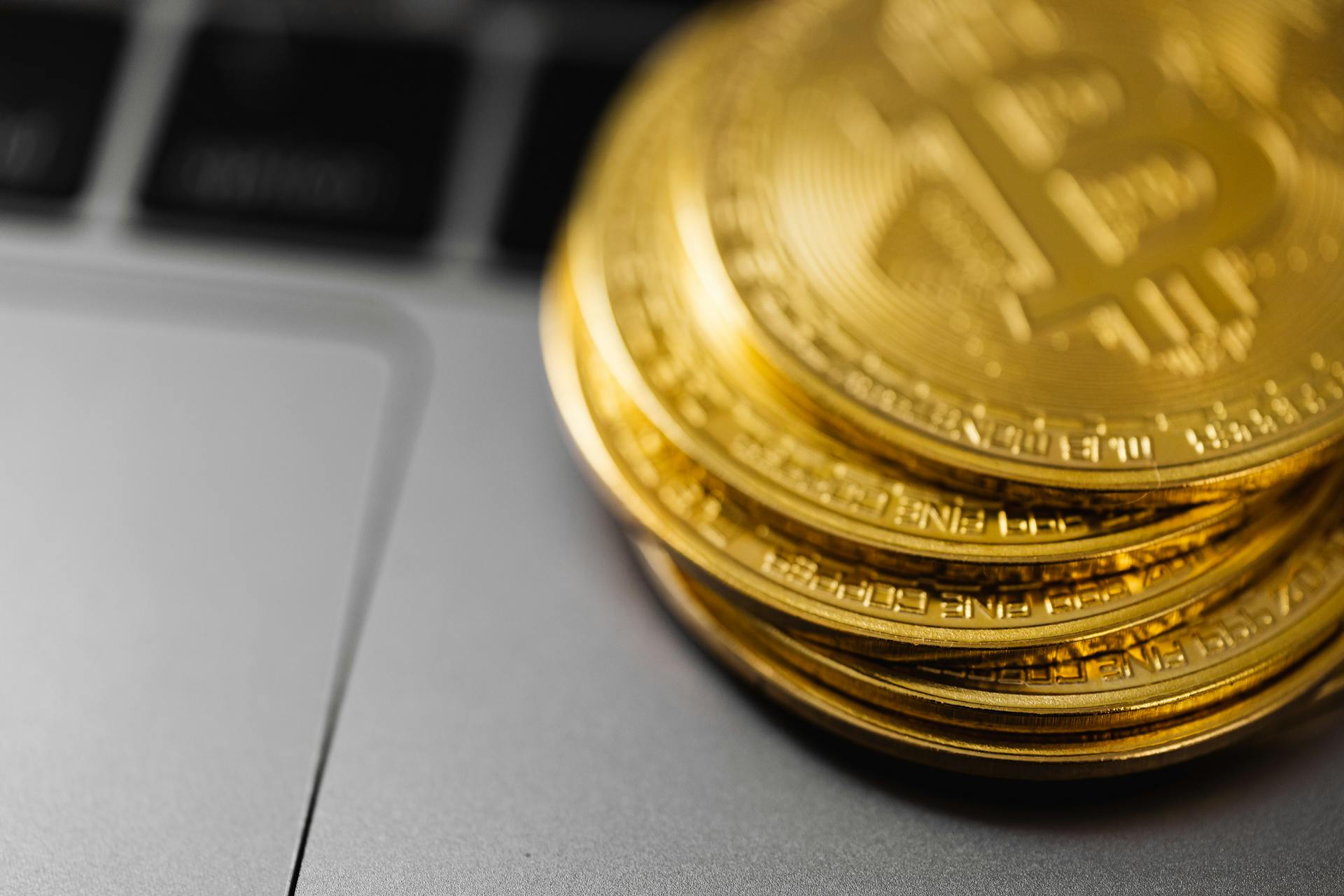 Close-Up Shot of Bitcoins on Laptop Computer