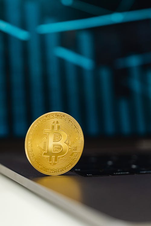 Free Selective Focus of a Bitcoin on Laptop Computer Stock Photo