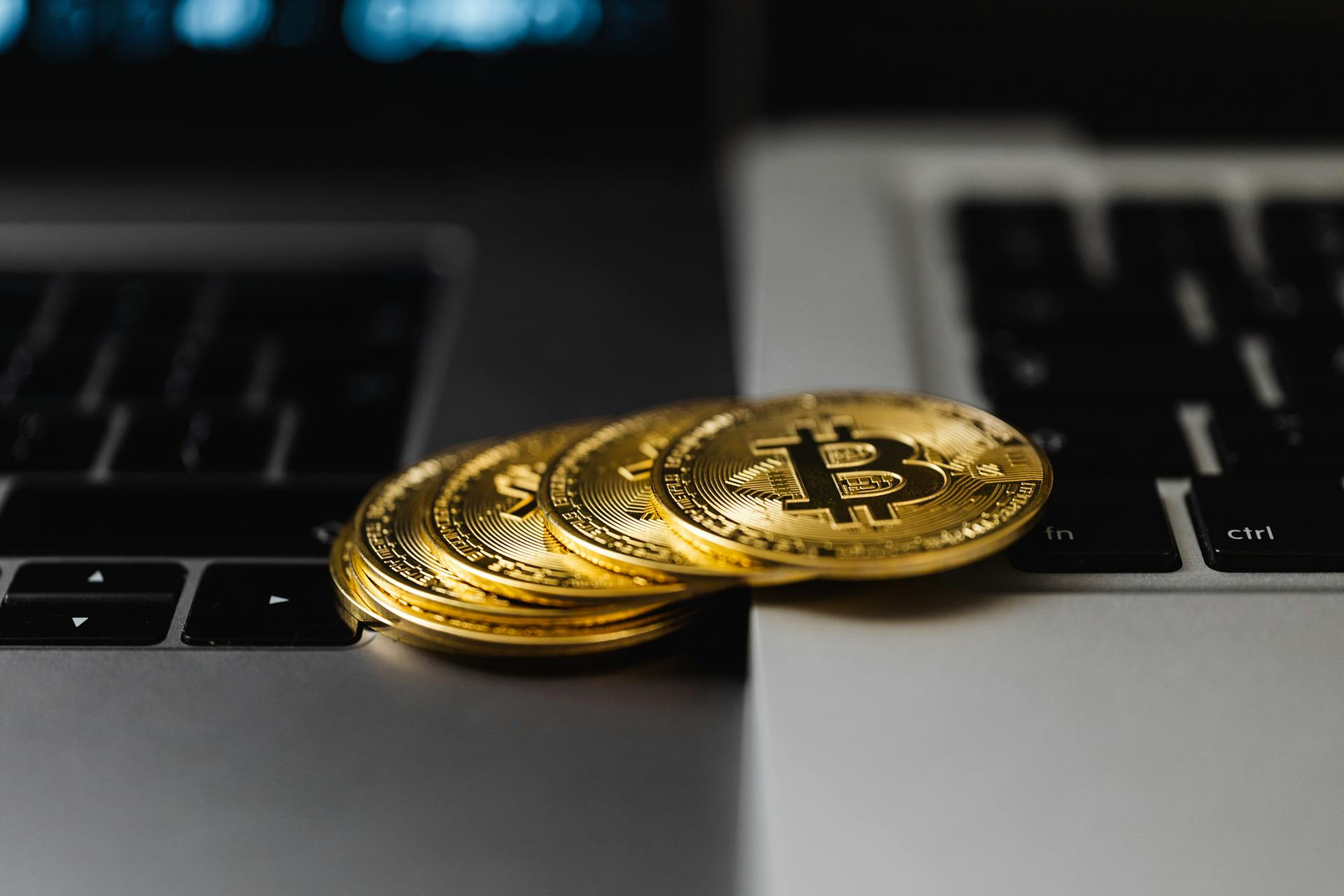 Close-Up Shot of Bitcoins on Laptop Computers