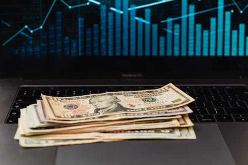 Free Us Dollar Bills on Top of Laptop Keyboard Stock Photo