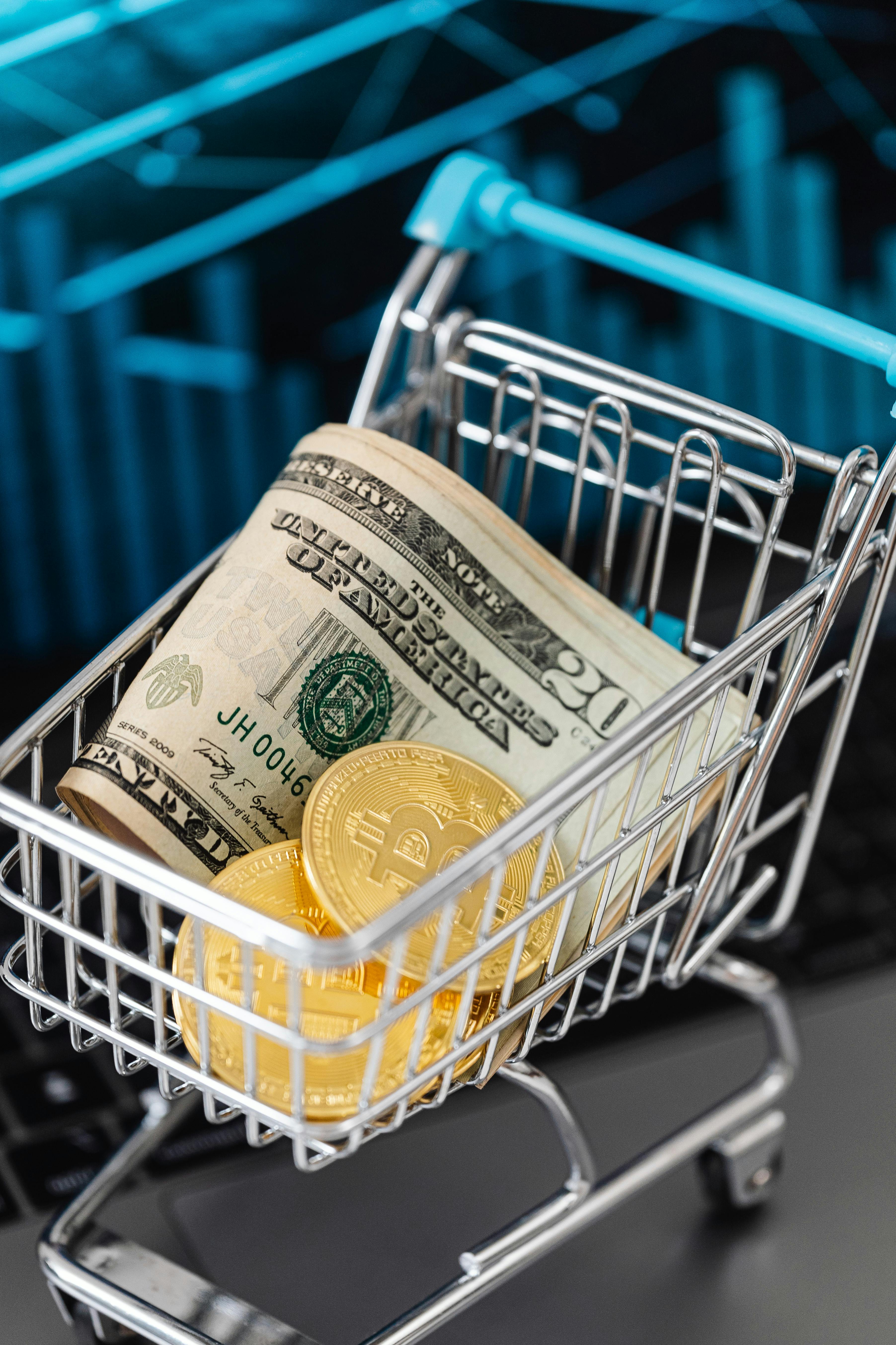 paper money and gold coins on a miniature cart