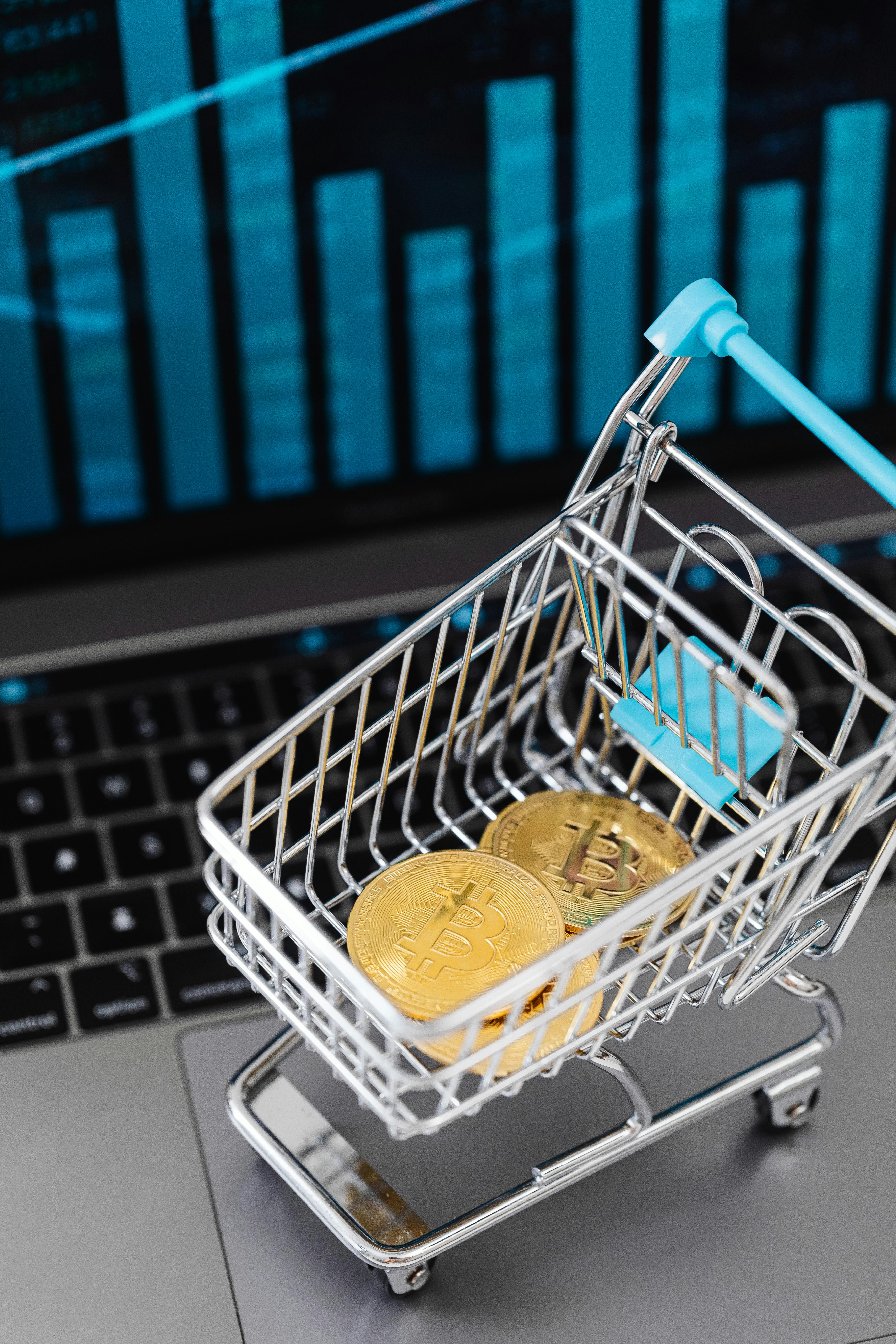 small shopping cart with gold bitcoins