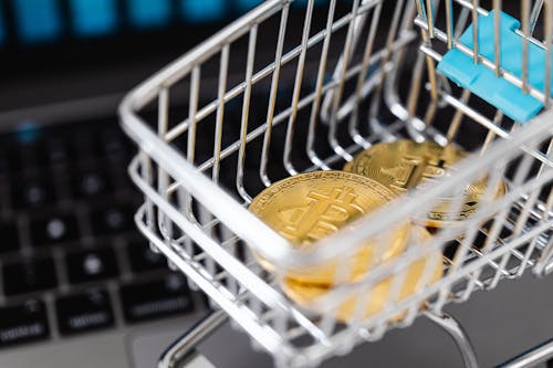 Gold Bitcoin Coins in a Miniature Shopping Cart 
