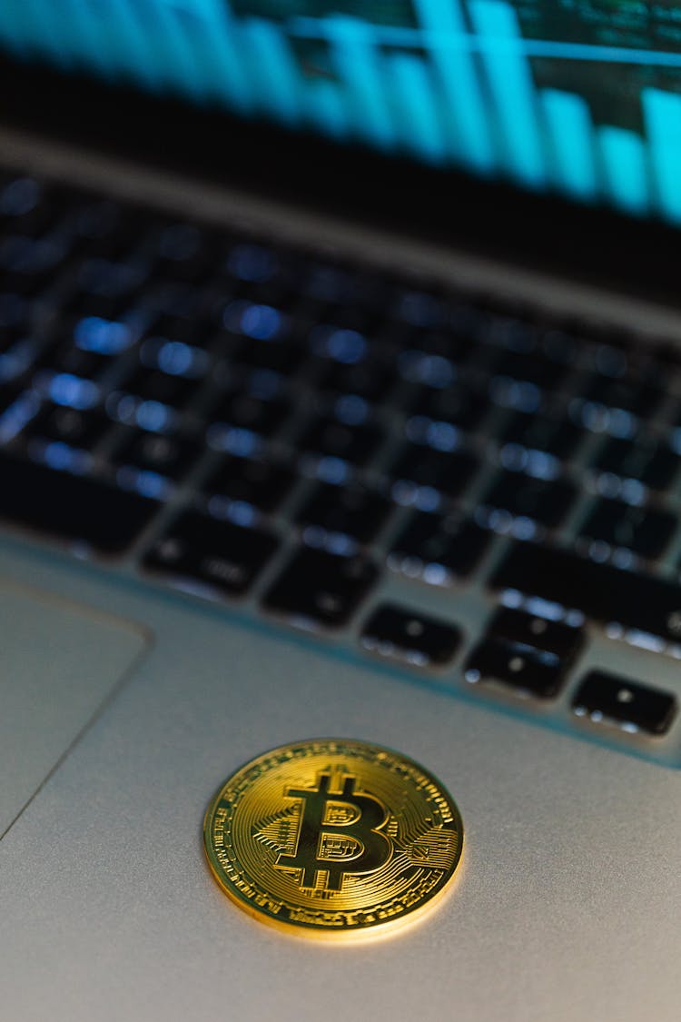 Gold Bitcoin Coin Lying On A Laptop 