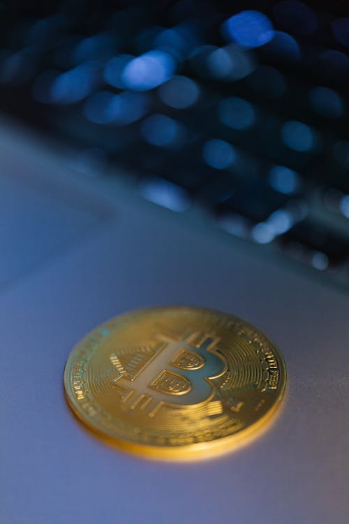 Close-up of a Gold Bitcoin Coin Lying on a Laptop 
