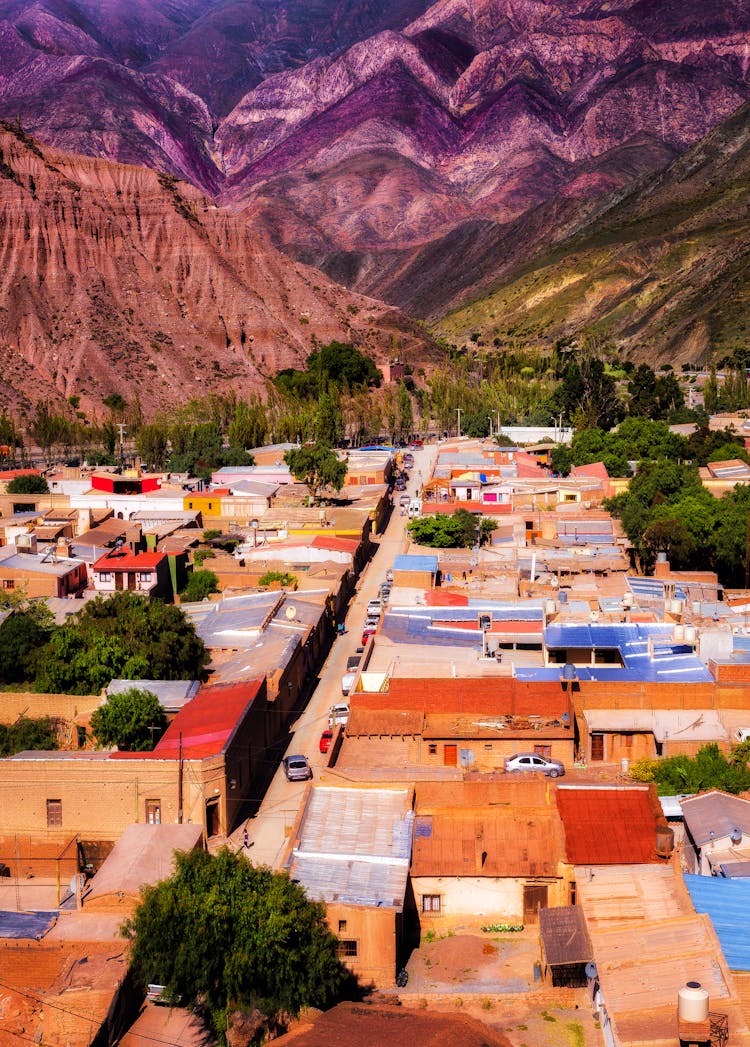 Colorful Rooftops In Town Surrounded By Mountains