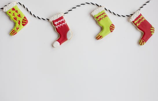 Colorful iced stocking-shaped cookies on a garland create a festive Christmas scene with copyspace.