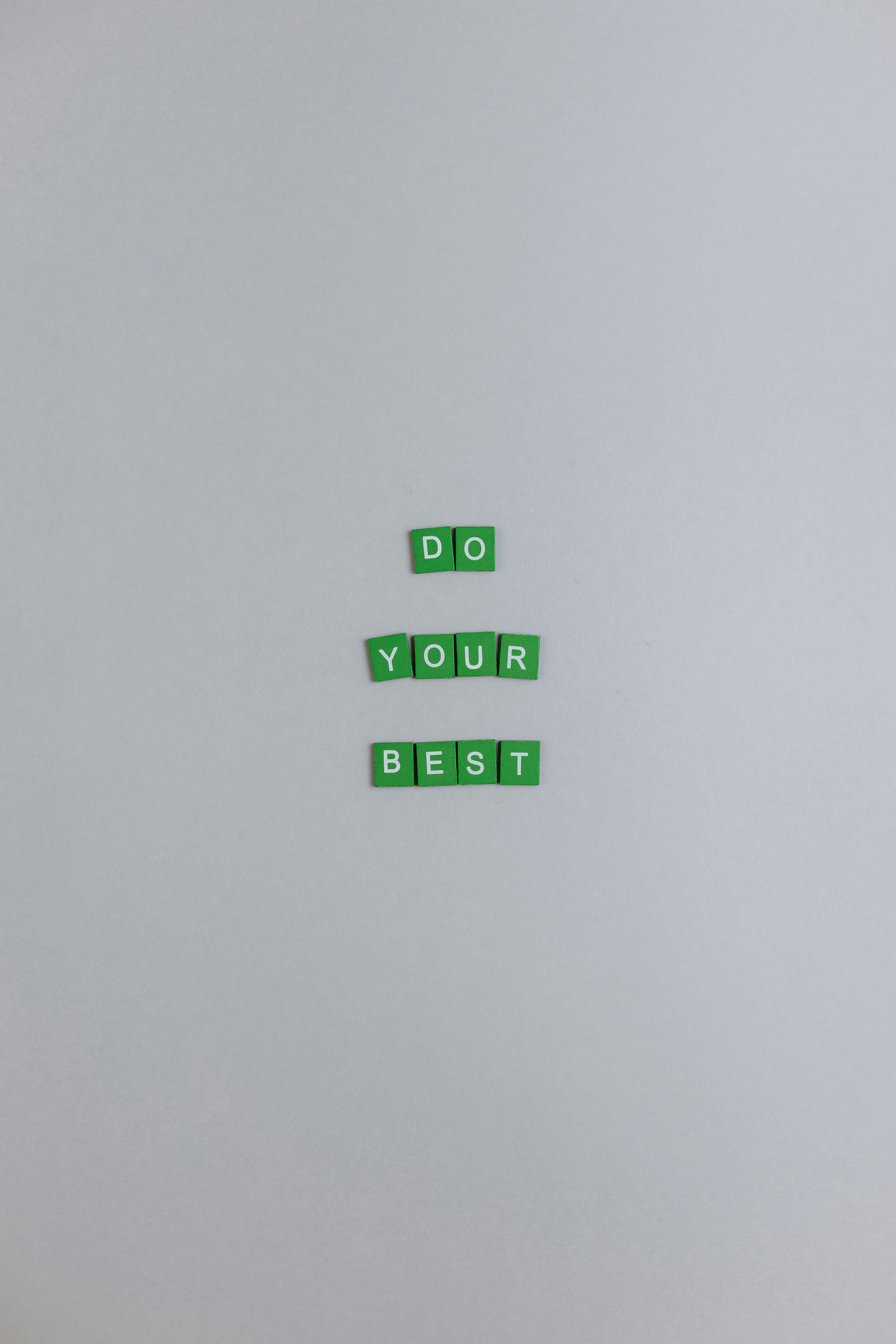 green scrabble tiles on a white surface