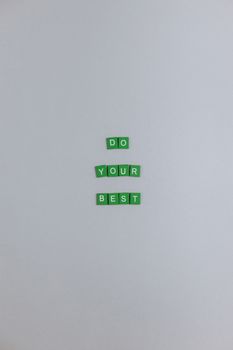 Motivational message 'Do Your Best' crafted with green letter tiles on white background.