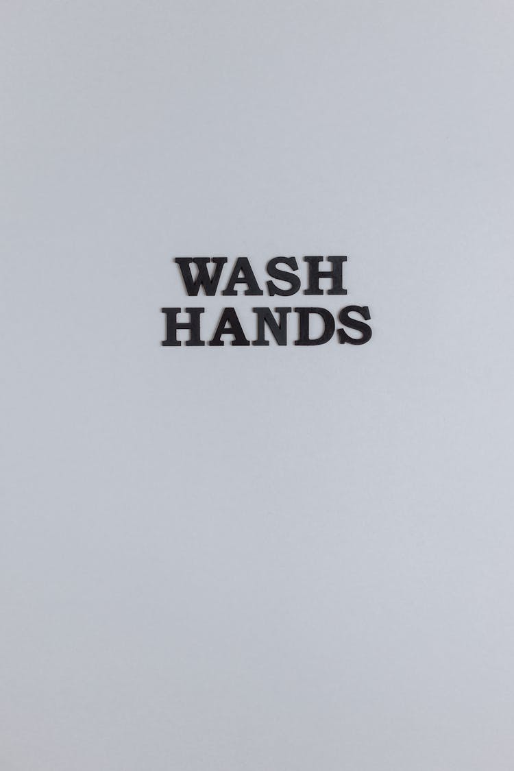 A Wash Hands Sign On Gray Surface 