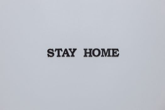 Simple minimalist text 'Stay Home' on a gray background emphasizing safety and precaution.