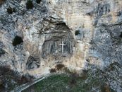 Drone view cross located in rough mountain cave