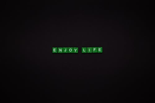 Enjoy Life Text On Green Tiles With Black Background