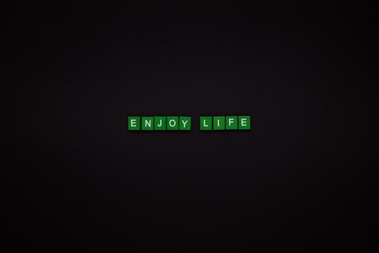 Enjoy Life Text On Green Tiles With Black Background