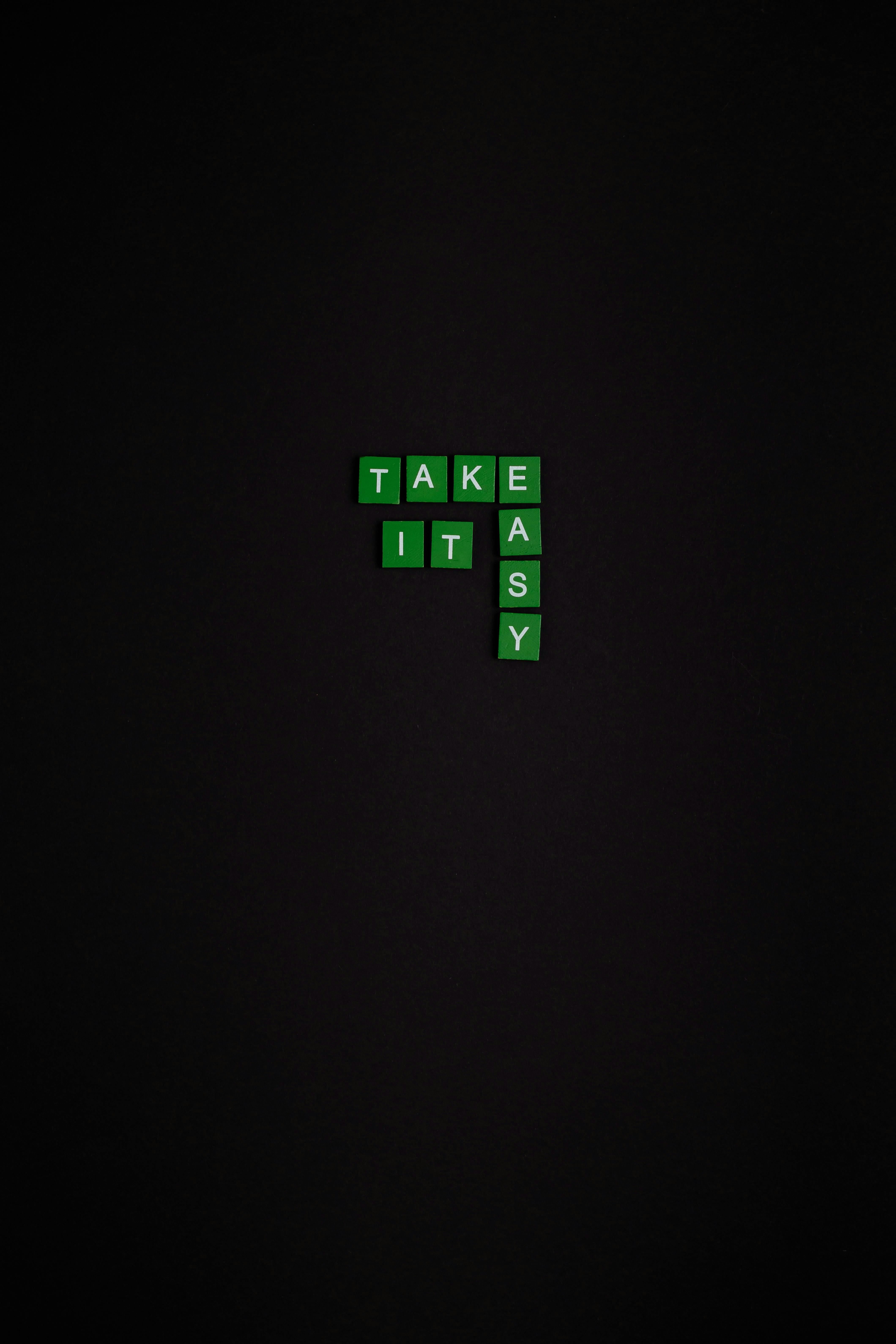 green and white text based tiles on black background