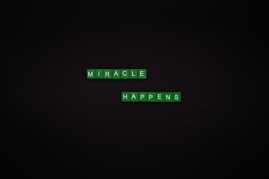Motivational image featuring the words 'Miracle Happens' using green tiles on a black backdrop.