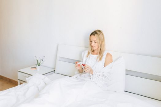Woman in White Tank Top Holding White Smartphone