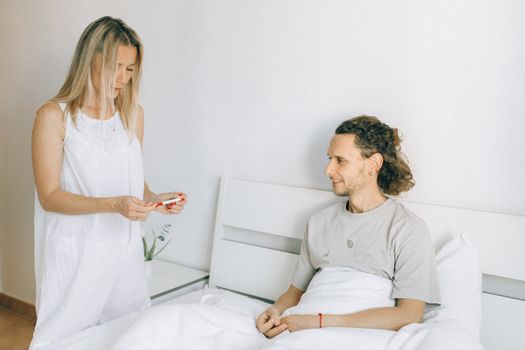 Man in Gray Crew Neck T-shirt Kissing Woman in White Dress