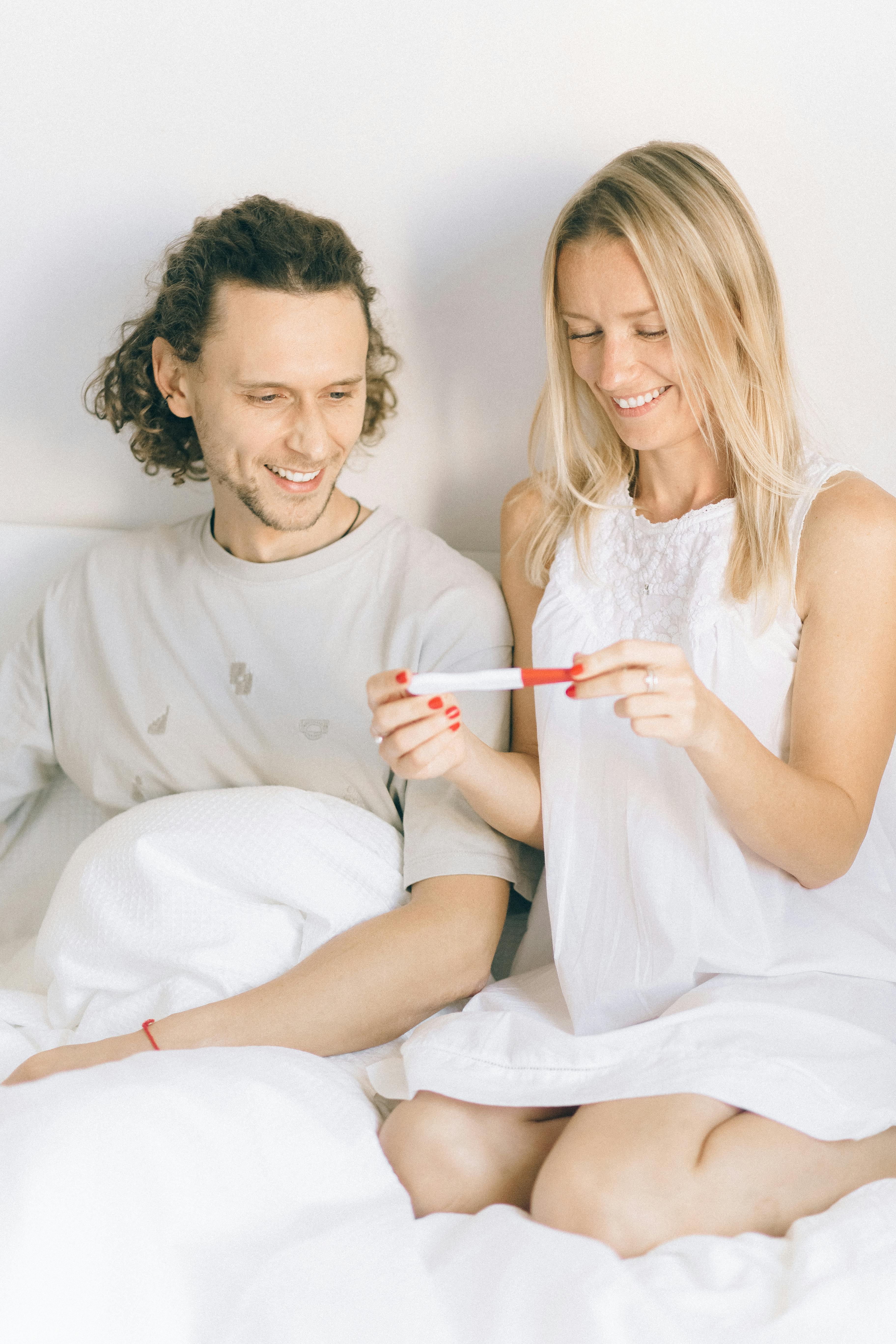 happy couple looking at the pregnancy test