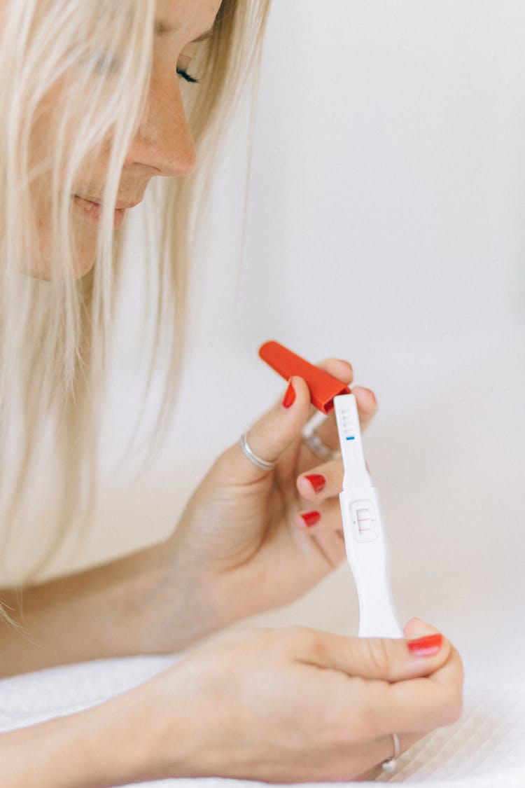 Woman Holding A Pregnancy Test With Two Lines 