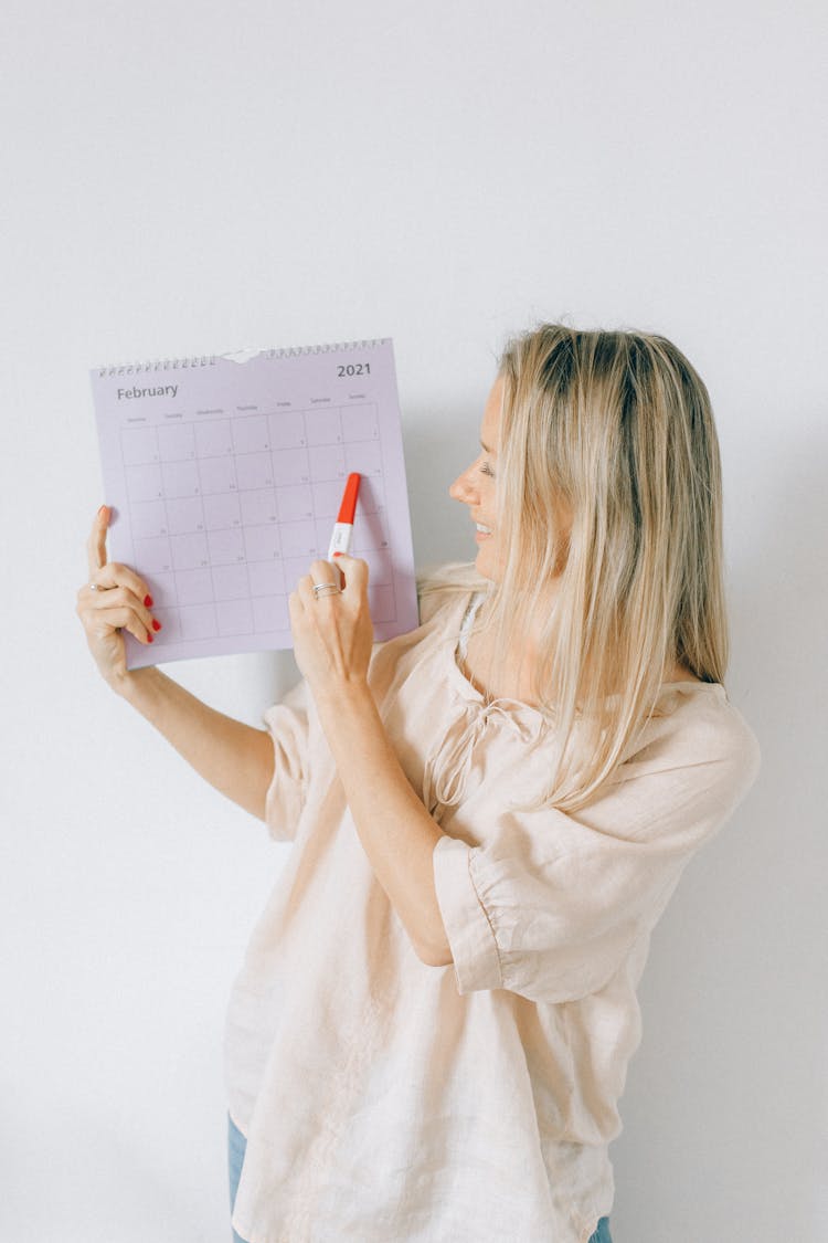 A Woman Holding A Calendar