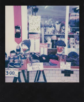 Polaroid-style photo of a shop window showcasing thermal hats and socks.