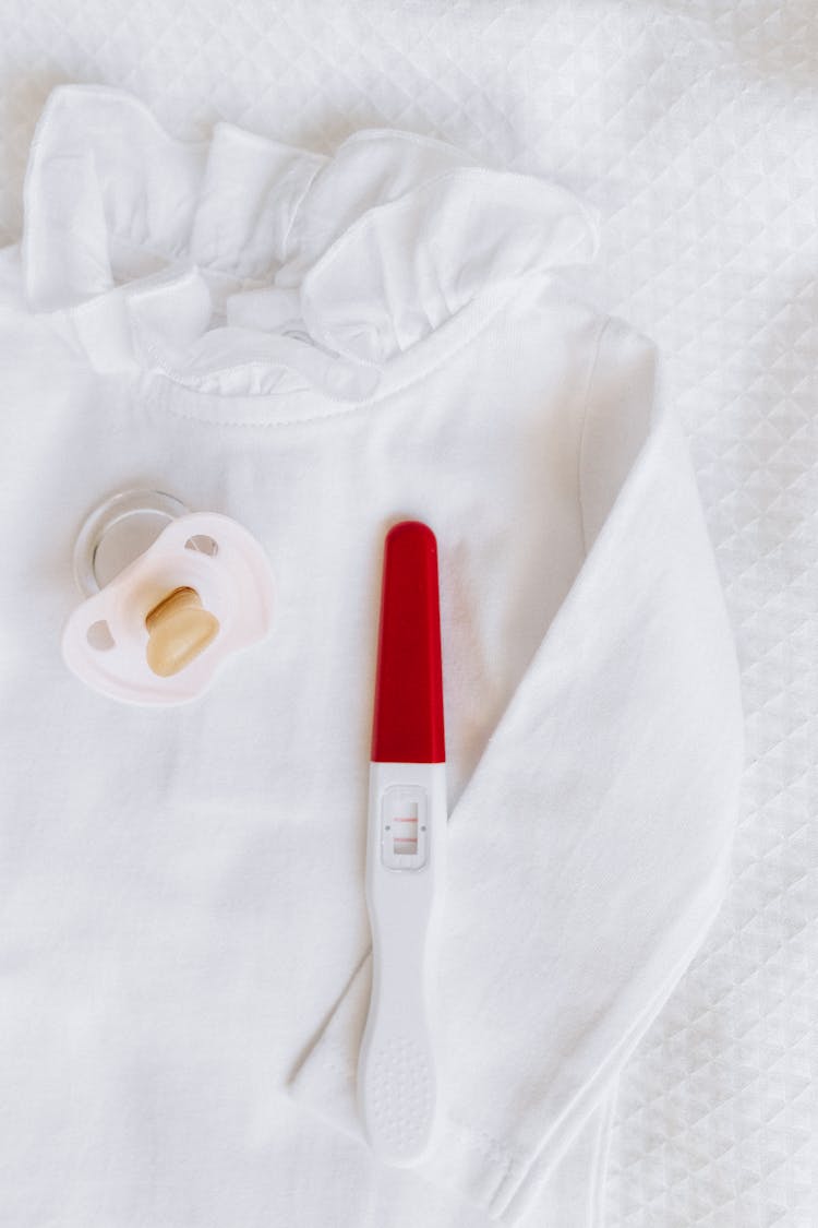 Pregnancy Test Kit Beside A Pacifier