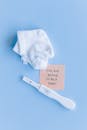 White Socks and Pregnancy Test Kit on Blue Background