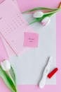Pink Sticky Notes on Pink Paper beside Pink and White Flowers