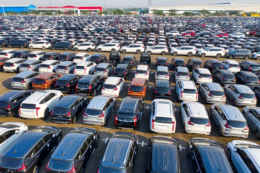 Aerial view of rows of new cars parked at a manufacturing facility
