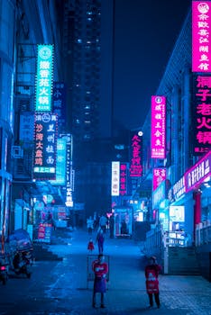 Capture the bustling energy of a Chongqing street at night under vibrant neon signs.
