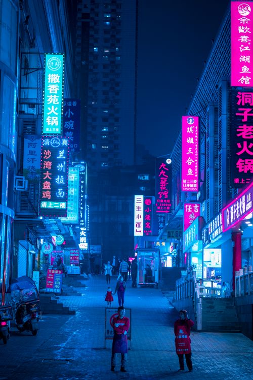 Free Capture the bustling energy of a Chongqing street at night under vibrant neon signs. Stock Photo