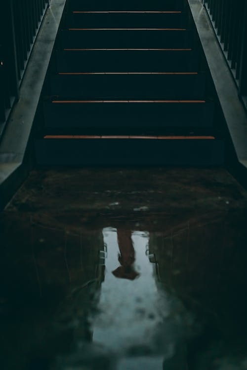 Wet public staircase in dark tunnel