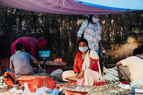 Free A lively street market in Butwal, Nepal with vendors selling fresh produce under colorful tents. Stock Photo