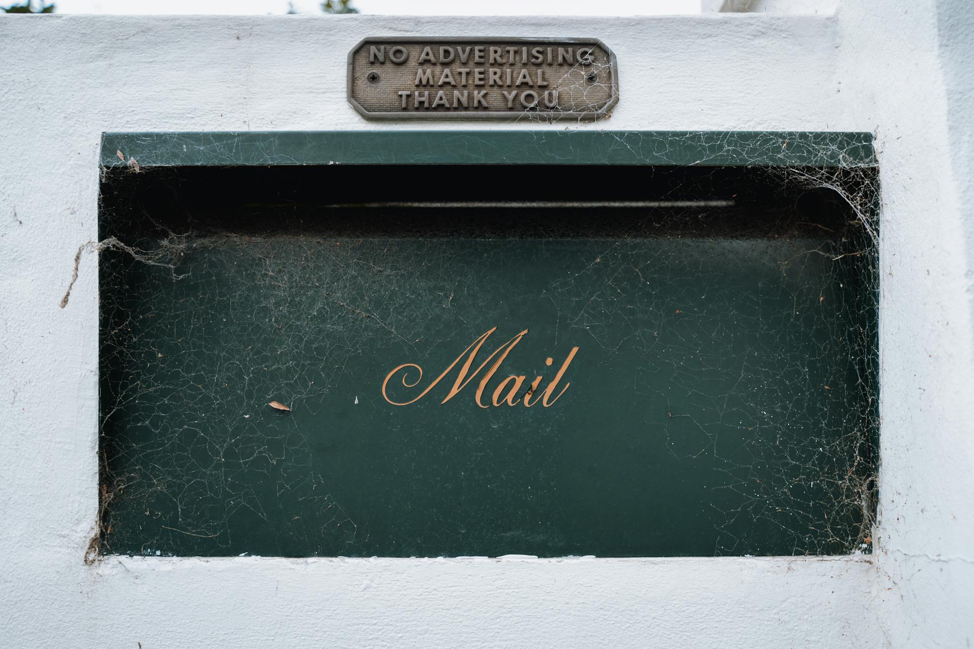 A detailed view of a vintage mailbox with cobwebs in Kurraba Point, NSW, Australia.