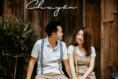 Free Happy Asian couple sitting on stairs Stock Photo