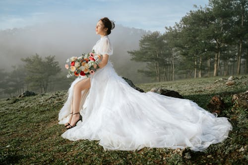 Beautiful Asian bride with bouquet of flowers