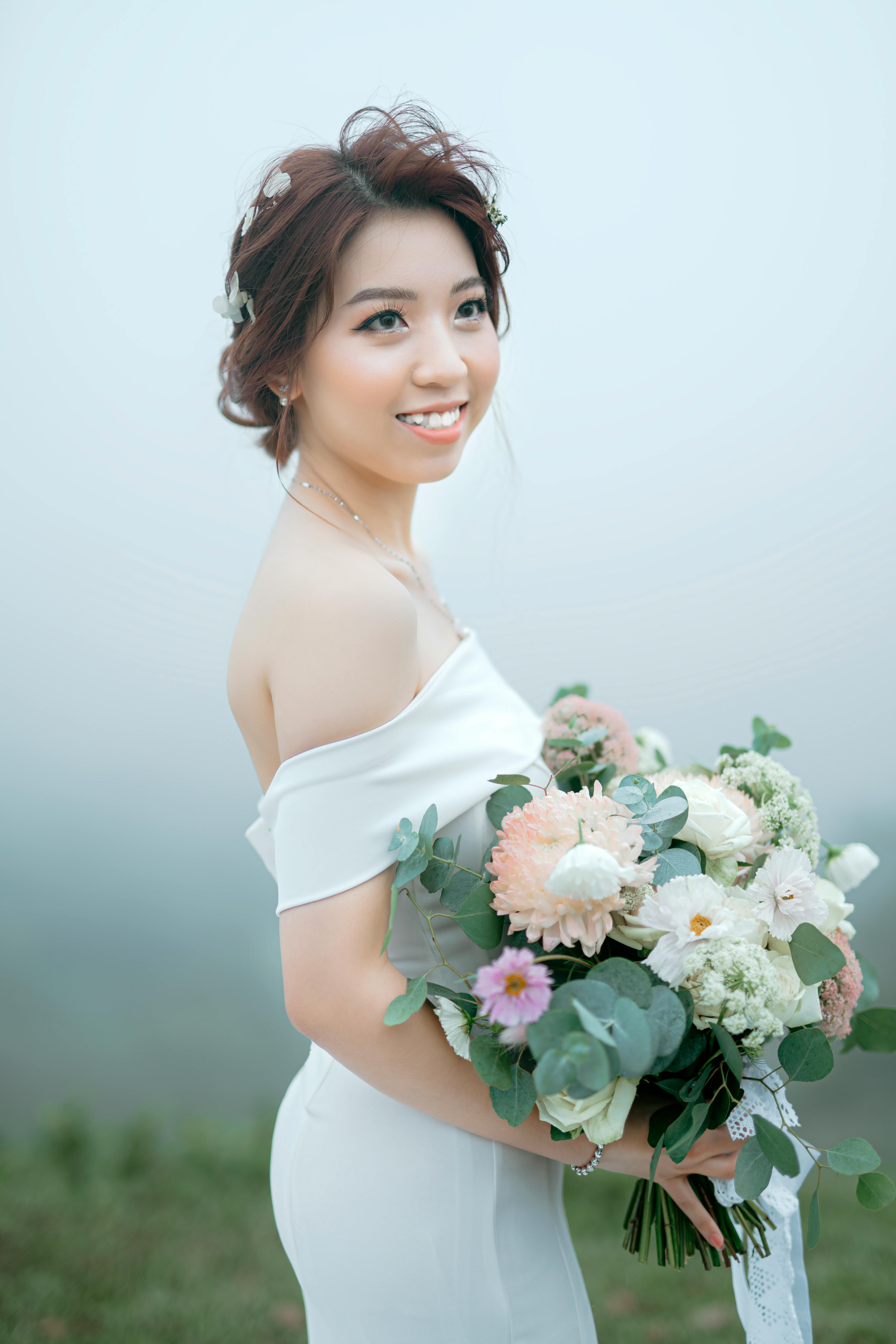 Gorgeous young woman with colorful flowers in hair · Free Stock Photo