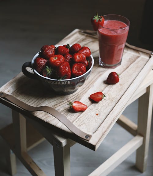 Close-Up Shot of Strawberries on a Metal Bowl beside a Strawberry Smoothie