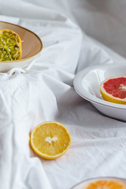 Delicious fruits on white blanket at home