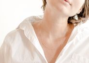 Crop gentle woman in white wear in shiny light