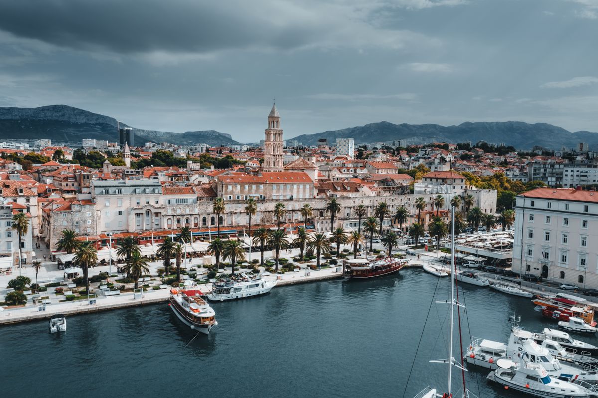 Aerial view of Split waterfront with boats, historic buildings and bell tower