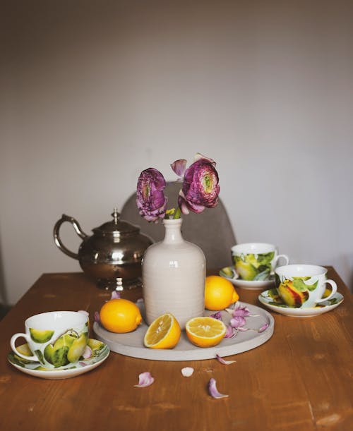 Free Tea set and bouquet of flowers on table Stock Photo